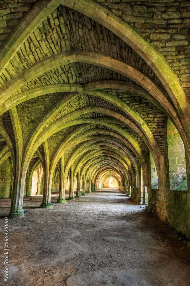 Fototapeta premium England, North Yorkshire, Ripon. Fountains Abbey, Studley Royal. UNESCO World Heritage Site. Cistercian Monastery. Ruins of vaulted cellarium where food was stored. 2017-05-03