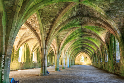England, North Yorkshire, Ripon. Fountains Abbey, Studley Royal. UNESCO World Heritage Site. Cistercian Monastery. Ruins of vaulted cellarium where food was stored. 2017-05-03 photo