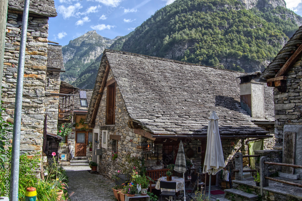 stone houses with geraniums on balconies in Sonogno, now Verzasca, Ticino canton, Switzerland