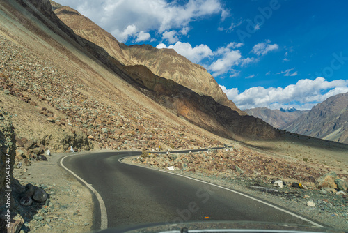 road with two sides are high mountains, and blue sky. Beautiful scenery on the way to Turturk Villgae, Leh, Ladakh, Jammu and Kashmir, India photo