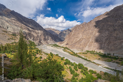 field seen from above and mountains and cloudy sky in Thang village, Ladakh. Thang is a part of Turtuk village, which was under Pakistan's control until 1971, after which India gained control of it.