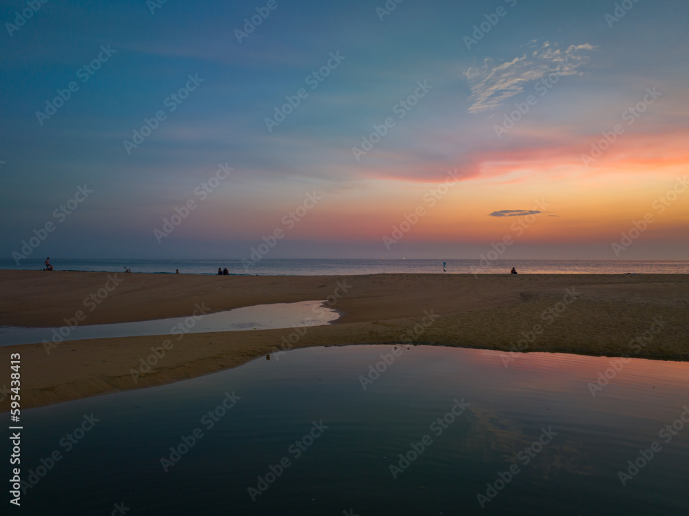 aerial view reflection of scenery romantic sky of sunset at Karon beach..reflection amazing sky of sunset in the swamp next to the beach..colorful sky background. amazing sunset over sea