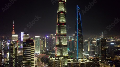 The drone aerial footage of Lujiazui financial and trade zone at night, Pudong, Shanghai, China. Lujiazui is the largest financial zone in mainland China. photo