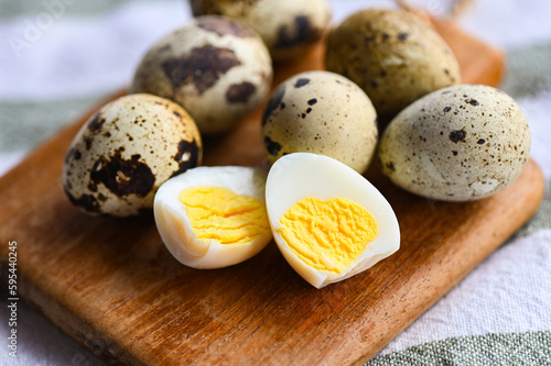 boiled eggs food, quail eggs on wooden plate, breakfast eggs with fresh quail eggs on table background