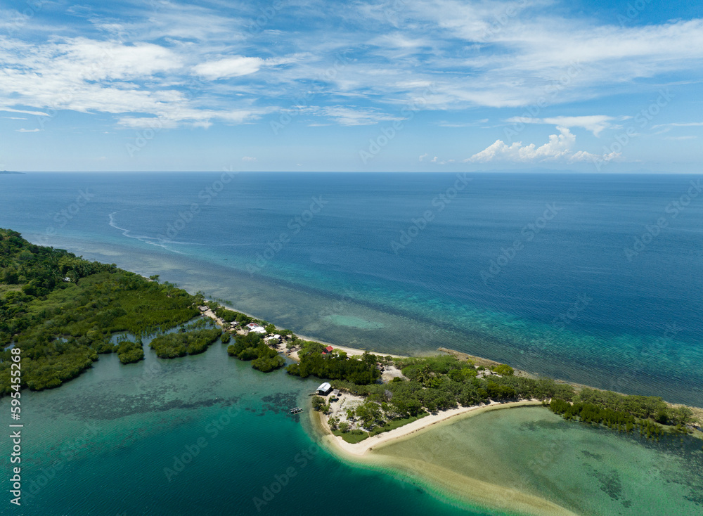 Top view of tropical island coastline and blue sea. Ocean and blue sky. Turtle Islands, Negros, Philippines