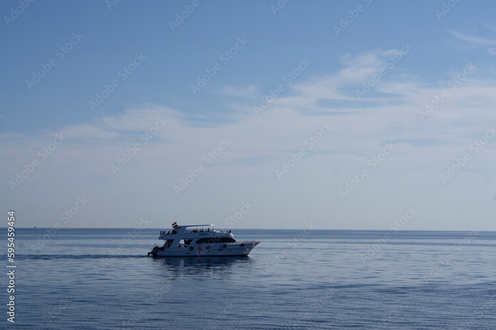 21.02.2022 Sharm el Sheikh, Egypt. A huge motor yacht underway. Luxury yachts with tourists in a bay of the Red Sea in Sharm El Sheikh in Egypt. Large luxury motor yacht under way sailing out.