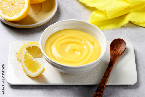 Homemade vanilla custard pudding or lemon curd in a white bowl.
