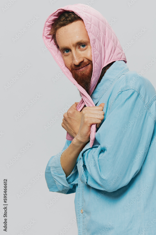 Funny man in a pink hat portrait on a light gray background. Smile and positive emotions. Funny man in a pink hat portrait on a light gray background. Smile and positive emotions.
