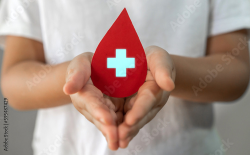 Child kid hand holding blood drop donation, save life, world hemophilia day concept, world blood donor day, hospital, life and health insurance, world mental health day
