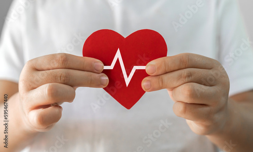 Child kid hand holding red heart paper cut, health and medical, love, heart health, heart attack, world heart day, cardiovascular disease, doctor, family, donation, insurance and hospital concept