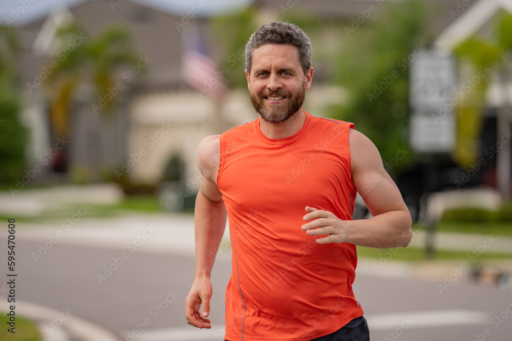 Fototapeta premium Running man sprinting workout outdoor. Fit athlete man running on american neighborhood.