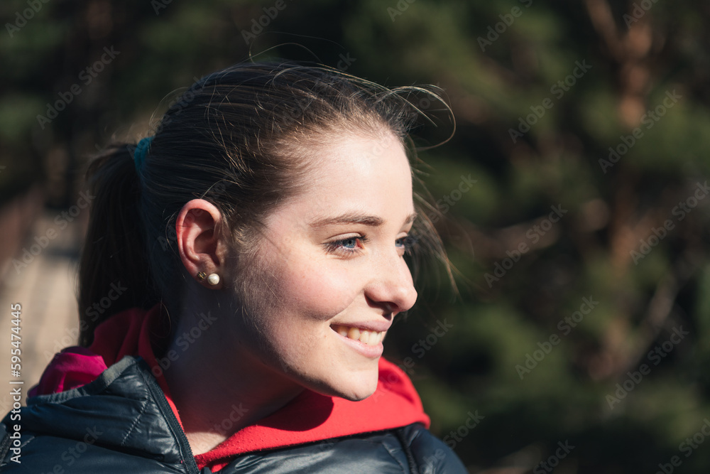 Portrait of a blue-eyed young woman smiling in nature Portrait of a blue-eyed young woman smiling in nature