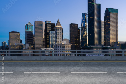 Empty urban asphalt road exterior with city buildings background. New modern highway concrete construction. Concept way to success. Transportation logistic industry fast delivery. Seattle. USA.