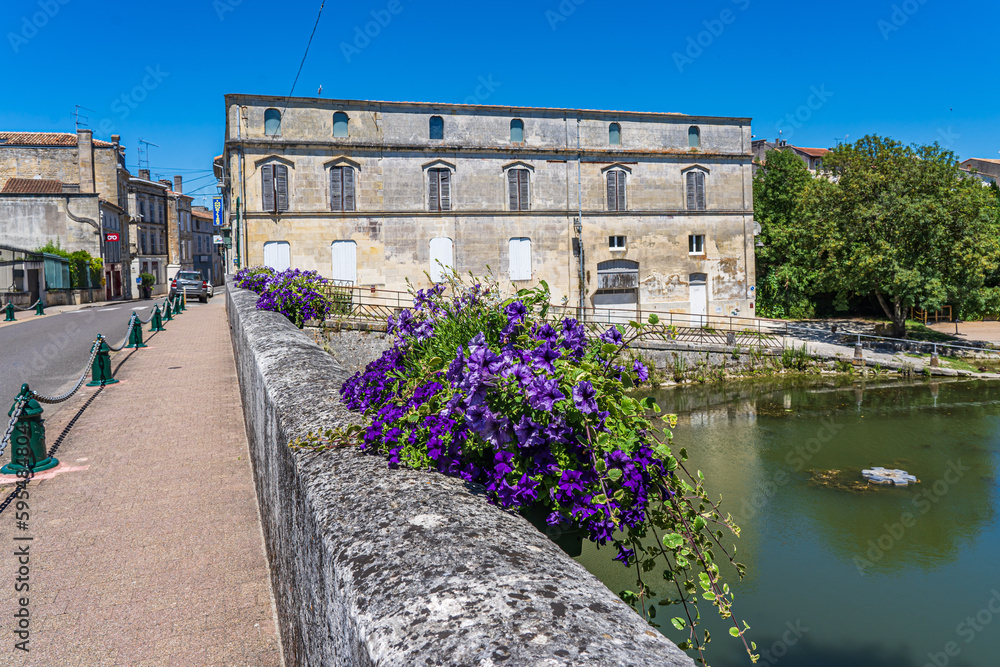 A town view of a river from bridge in the French city of Jonzac