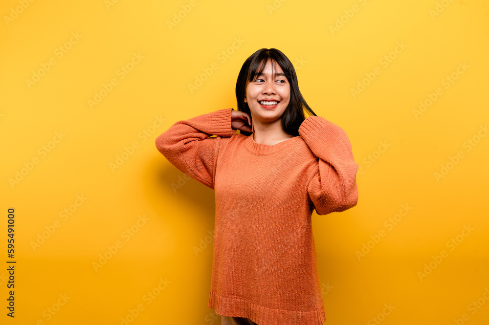 Cute Asian girl smiling on yellow background. Empty, young woman. Place for advertisement. copy space Cute Asian girl smiling on yellow background. Empty, young woman. Place for advertisement. copy space