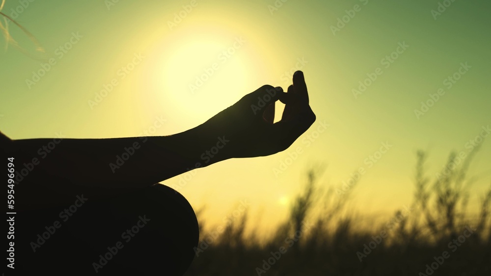 hand sunset in the sky. yoga woman at sunset. silhouette female sport. girl young nature evening. dawn outdoors. concentration. one love nature. sports one relaxation. relax outdoors. yoga.