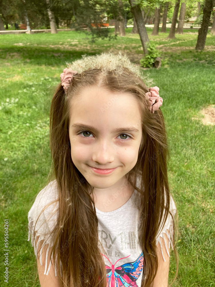 portrait of a little girl with a crown of dandelion fluff portrait of a little girl with a crown of dandelion fluff