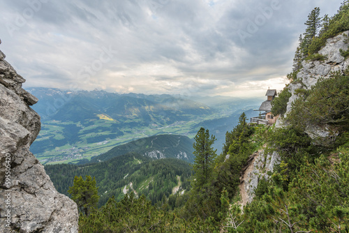 View on a charming small mountain chapel built on the edge of a mountain cliff overlooking the valley in the austrian Alps on Stoderzinken mountain. Dachstein mountains. © Dirk