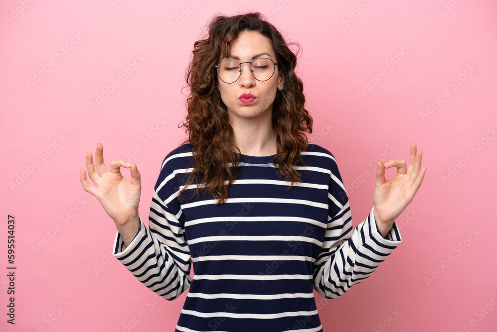 Young caucasian woman isolated on pink background in zen pose Young caucasian woman isolated on pink background in zen pose