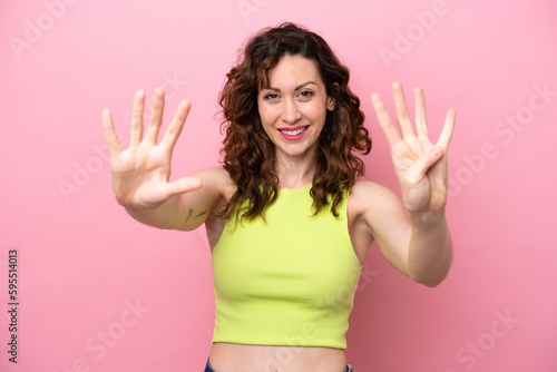 Young caucasian woman isolated on pink background counting nine with fingers