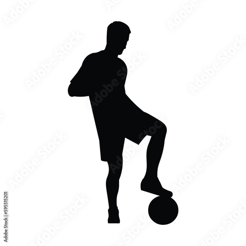 Football player silhouette stands in a half-turn, placing his foot on the ball