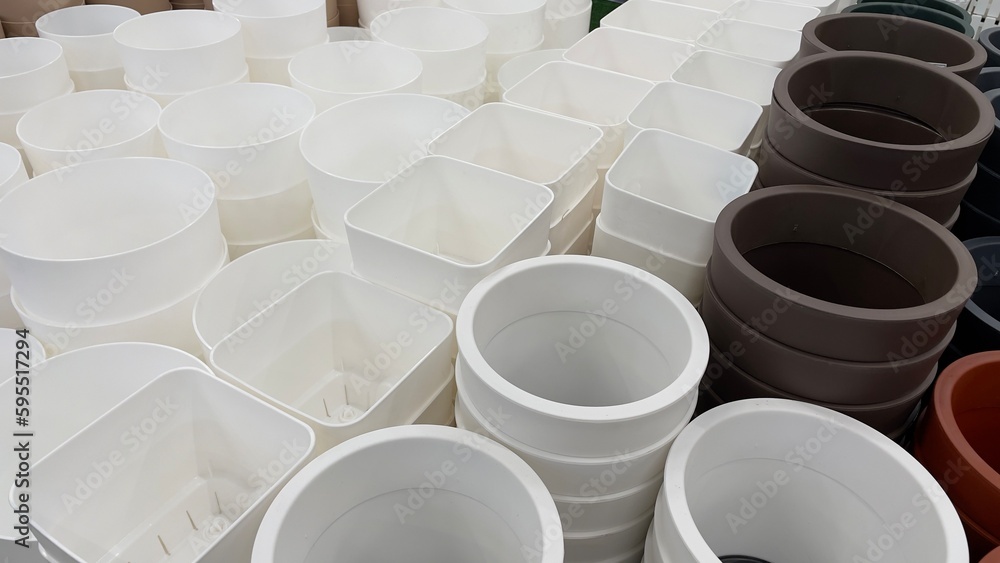 Close-up of empty flower pots in a store or greenhouse. Colorful pots for plants. Gardening and landscape design concept Close-up of empty flower pots in a store or greenhouse. Colorful pots for plants. Gardening and landscape design concept