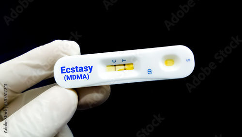 MDMA or Methylenedioxymethamphetamine Rapid test cassette, also known as Ecstasy or Molly in doctor hand showing positive result.