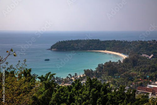 Beautiful beach with colorful water. Top view of the beautiful coastline. Sunny summer day. Colorful water. Sandy beach.