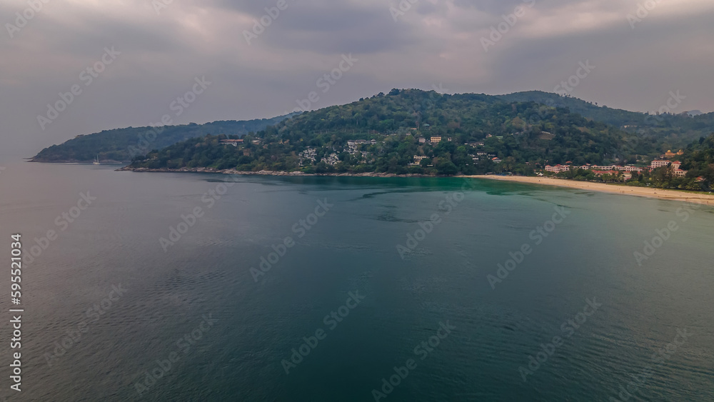 Beautiful beach with colorful water. Top view of the beautiful coastline. Sunny summer day. Colorful water. Sandy beach.