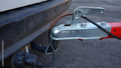 Trailer connected to car. Trailer on car's hook. Car hitch.
