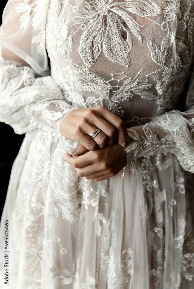 a positive bride in a beautiful wedding dress with lace is in a hotel room and is waiting for a meeting with the groom. beauty wedding day. a positive bride in a beautiful wedding dress with lace is in a hotel room and is waiting for a meeting with the groom. beauty wedding day.