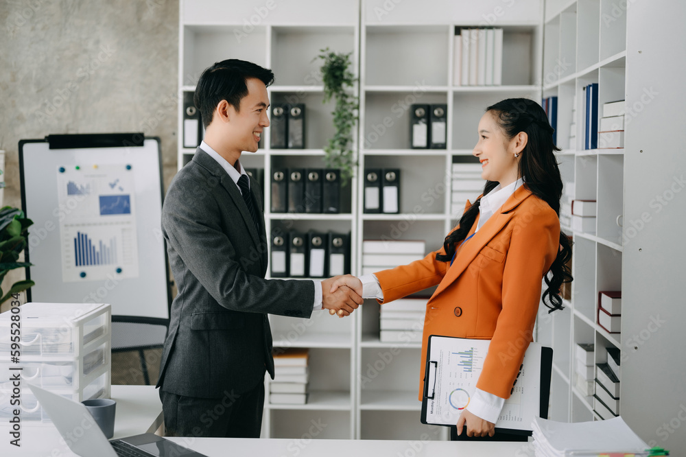 Two confident business man shaking hands during a meeting in the modern office, success, dealing, greeting and partner