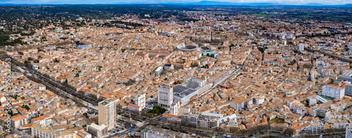 Aerial around the city Nimes on a sunny day on a late afternoon in early spring.