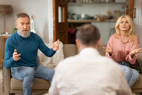 Unhappy Spouses Having Marital Therapy Session With Professional Psychologist Indoors