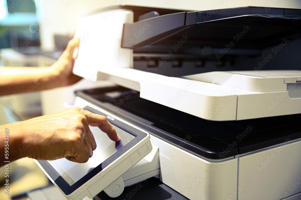 Photocopier printer, Close up hand office man press copy button on panel to using the copier or photocopy machine for scanning document or printing paper or Xerox a sheet. Photocopier printer, Close up hand office man press copy button on panel to using the copier or photocopy machine for scanning document or printing paper or Xerox a sheet.