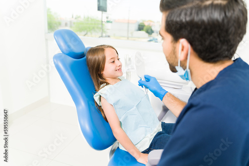 Happy young kid at the pediatric dentist with healthy teeth