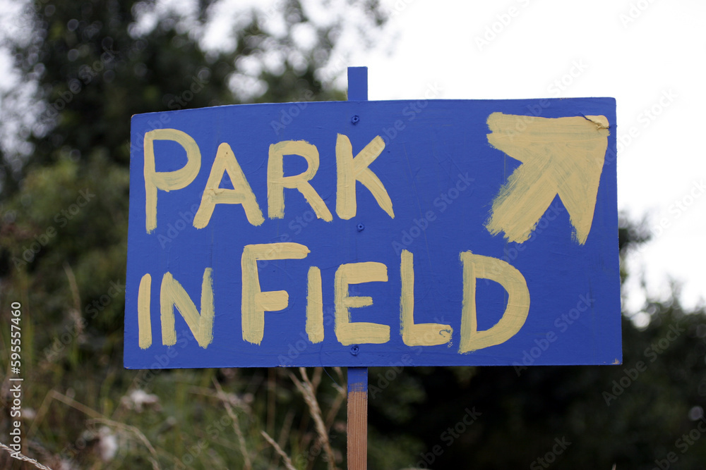 Sign painted white on blue 'park in field' - Catterline - Scotland - UK Sign painted white on blue 'park in field' - Catterline - Scotland - UK