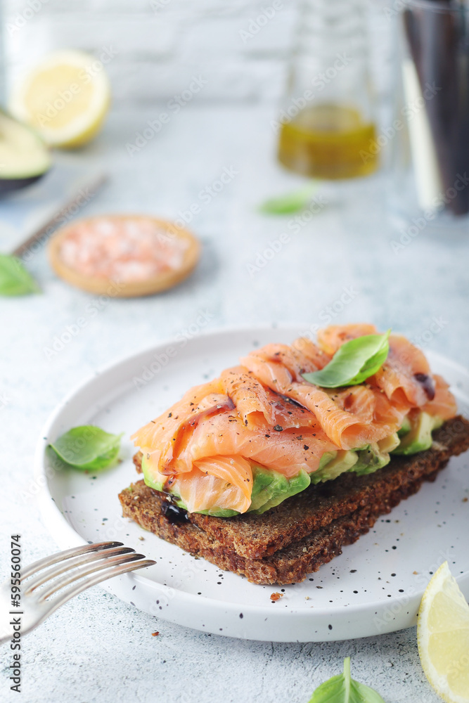 A rye bread sandwich with avocado and salmon A rye bread sandwich with avocado and salmon