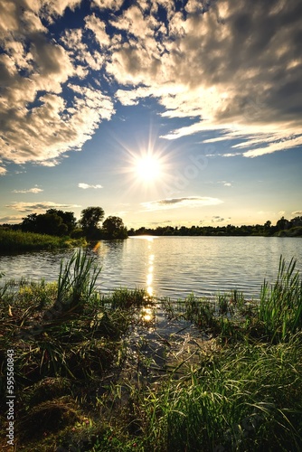 Beautiful colorful landscape by the lake in the countryside. Sunset on the Mojcza lake near Kielce, Poland.