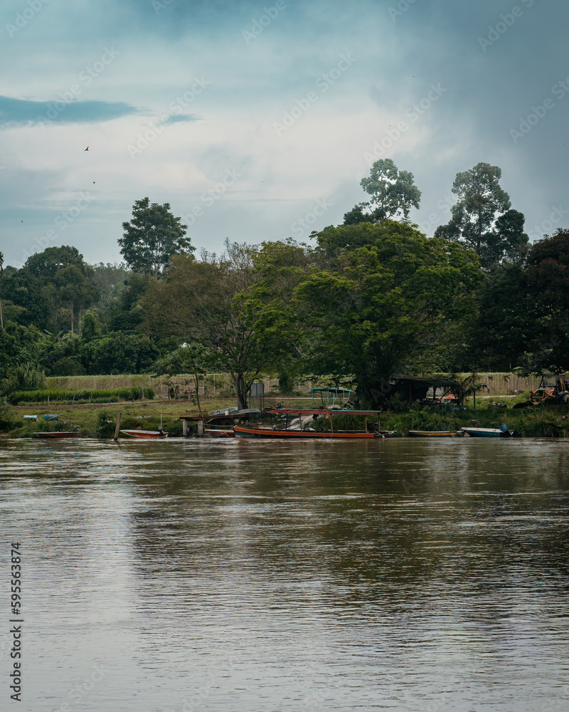 River banks with wooden boats in Kuala Kangsar, Malaysia. River banks with wooden boats in Kuala Kangsar, Malaysia.