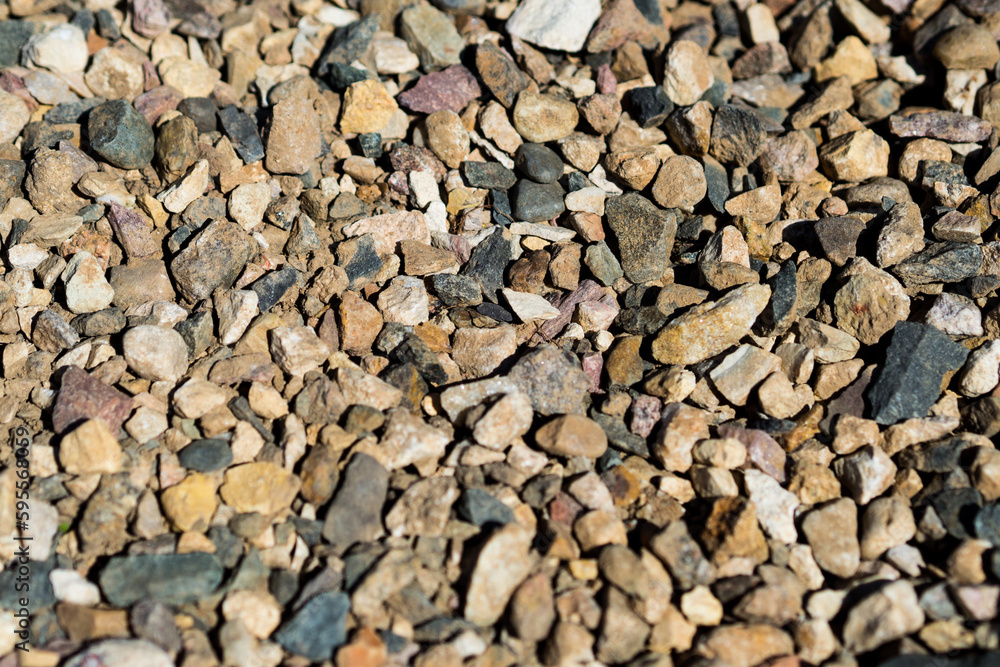 Smooth background with a texture of different sizes of pebbles. Pebble beach. Close-up. Smooth background with a texture of different sizes of pebbles. Pebble beach. Close-up.