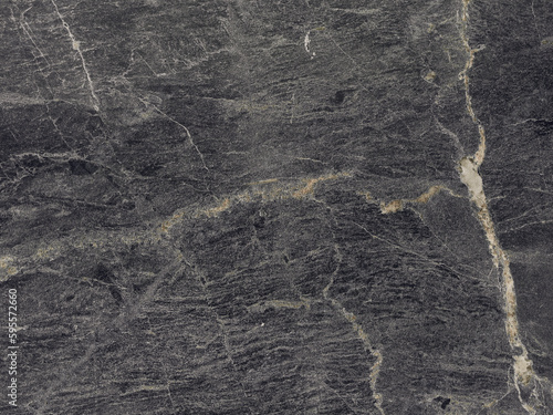 Patterned nature of dark gray marble texture with beige stripes