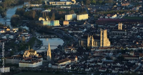 Aerial view of the medieval city of Auxerre, France. Aerial view of the city center and rooftops. The drone flies over the city at sunset. View of beautiful streets in the center of Auxerre