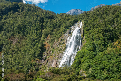 Magnificent waterfall, Milford Sound (Piopiotahi) fjord, Fiordland National Park in the south west of New Zealand's South Island. World heritage site among the world's top travel destinations