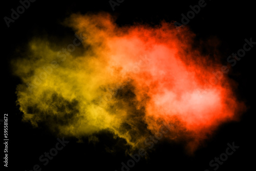 Colored powder explosion on black background. Freeze motion of colored powder explosion isolated. © Philip