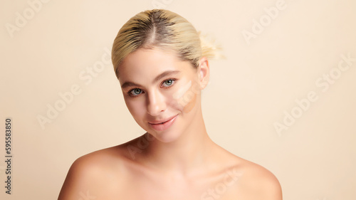 Beautiful smiling woman with tone cream lines on her face, girl with perfect makeup on white background, Skin care concept.