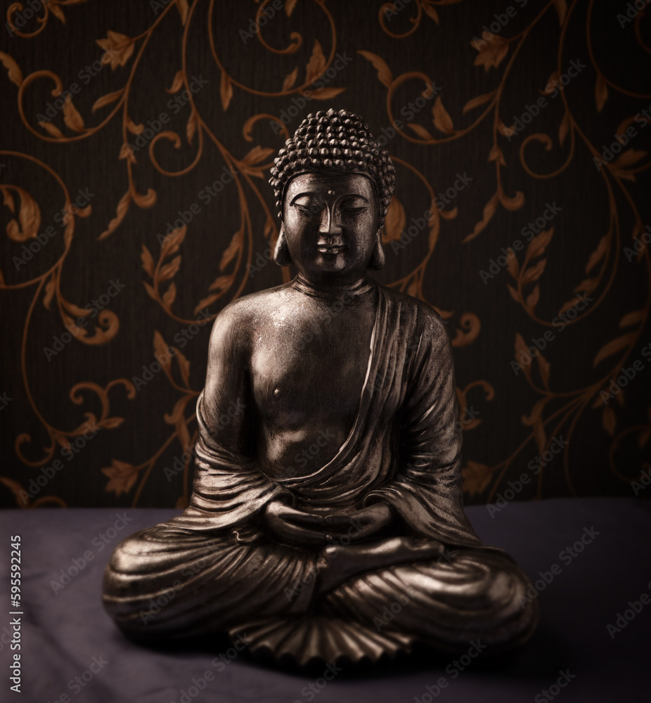 Meditating Buddha Statue on dark background. Soft focus. Close up. Copy space.