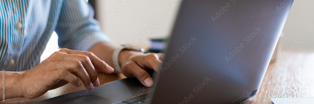Close up hands of businesswoman typing data on laptop keyboard while working on the desk in office Close up hands of businesswoman typing data on laptop keyboard while working on the desk in office