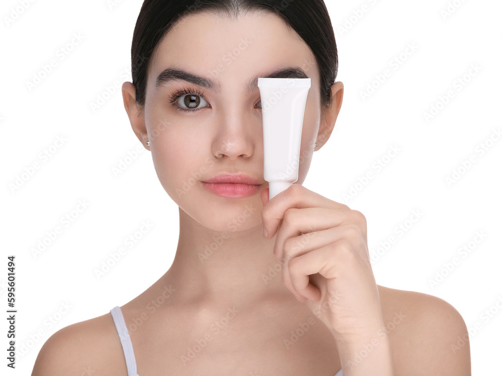 Teenage girl holding tube of foundation on white background Teenage girl holding tube of foundation on white background