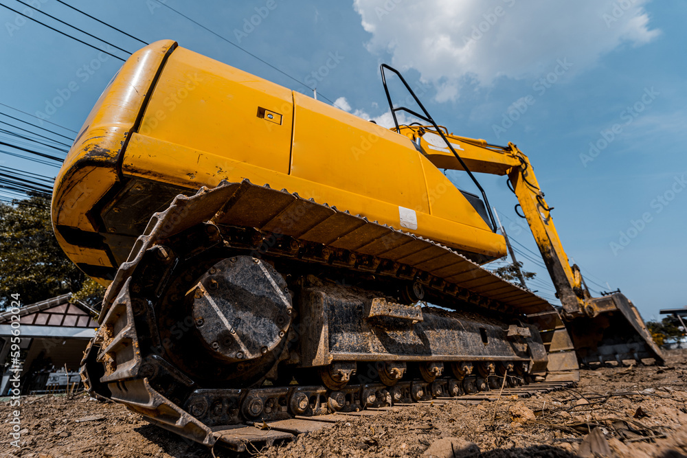 Excavator with shovel digs the ground for the foundation at constuction area. Excavator with shovel digs the ground for the foundation at constuction area.